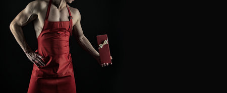 valentines day present in hand of muscular man isolated on black. happy valentines day.