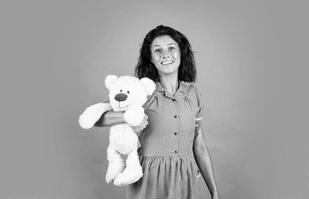 woman feel happy about present. love playing with fluffy toys. happy girl with bear toy present. holiday shopping sales. valentines day concept. best gift ever. gift of loveの写真素材