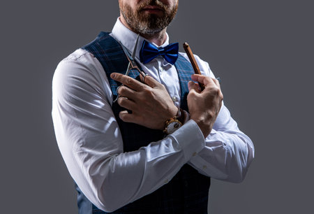 barber man isolated on grey background. barber man with scissors and blade.の写真素材