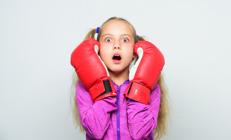Boxer child workout, healthy fitness. knockout and energy. Sport success. Sport and sportswear fashion. little girl in boxing gloves punching. training with coach. Fight. watching scoreの写真素材