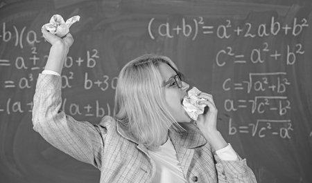 Teacher eats piece of paper absorb information. Teacher ready to eat her paperwork. Woman teacher...