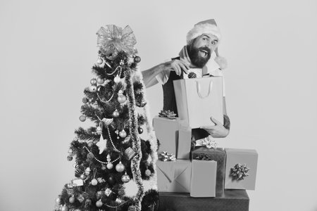 Black Friday sale. Guy in red hat with shopping bagsの写真素材