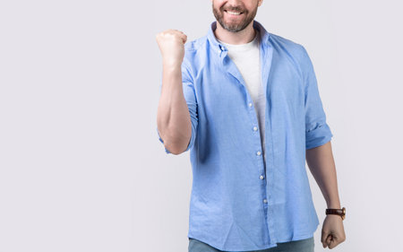 winning man win with yes gesture isolated on grey with copy space. winning man win with yesの写真素材