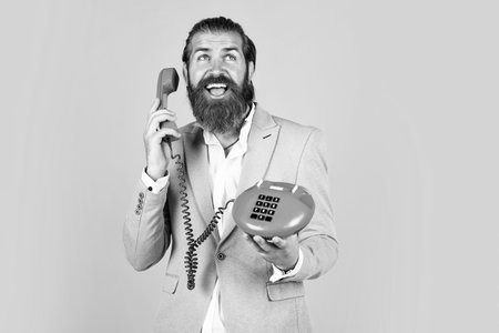 mature bearded male guy looking elegant hold retro phone, hi
