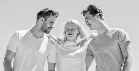 Lovely atmosphere. happy woman and two men. cheerful friends. friendship relations. family bonding and love. summer vacation. time to relax. group of people outdoor. heaven concept. success heightsの写真素材