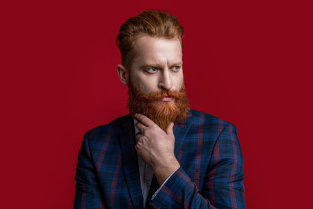 charismatic formal man in menswear isolated on red. formal man in menswear at studio.の写真素材