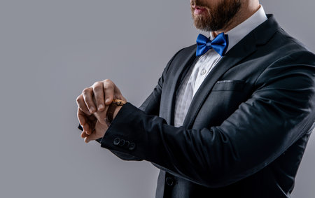 photo of man wearing formal tuxedo and wristwatch. man wear formal tuxedo menswear.の写真素材