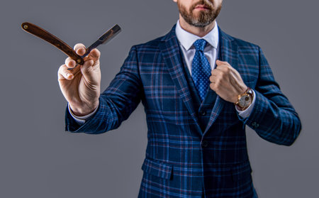 barber man with razor blade, selective focus. man with blade in barber studio.の写真素材