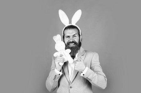 it is so lovely. mature guy wear rabbit ears. happy easter. spring holiday and party. funny bearded hipster in bunny ears. celebration concept. brutal handsome man with moustacheの写真素材
