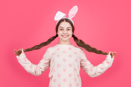 happy easter kid girl in bunny rabbit ears and pajamas, easterの写真素材