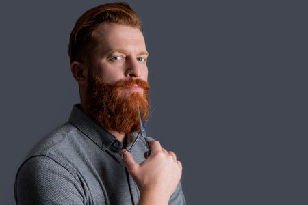 man hairdressing with barber scissors, copy space. barber man in hairdresser studio. barber manの写真素材