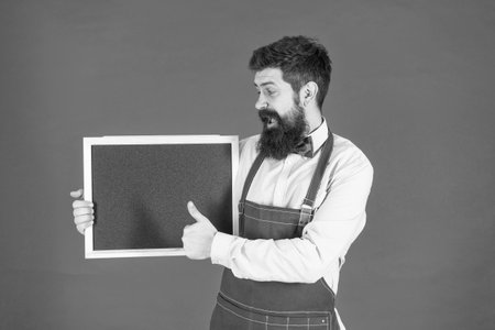 We are hiring. Happy barber show thumbs up holding hiring board. School chalkboard for advertisementの写真素材