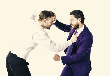 Businessmen fighting at workplace. Business conflict concept. Young men in formal wear or businessmの写真素材