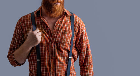 retro elegant man in suspenders at studio, copy space. retro elegant man in suspendersの写真素材