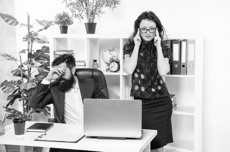 Get back to work. Man and woman work in office. Boss and secretary at workplaceの写真素材