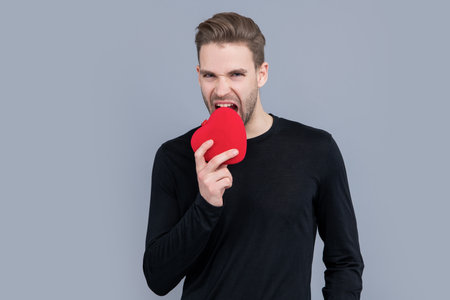 valentines day and love. heart love present of man for valentines day. man bite love heart presentの写真素材