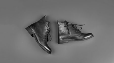 stylish leather boots on blue background, footwear