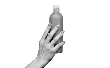 female hands hold lotion bottle with copy spaceの写真素材