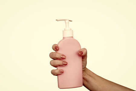 female hands hold liquid soap bottle with copy spaceの写真素材