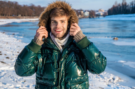 positive stylish man in winterwear outdoor. man in winterwear at holidays.の写真素材