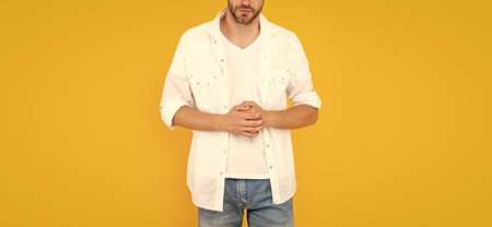 cropped man with bristle in white tshirt. young man with beard on yellow background.の写真素材