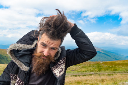 photo of bearded man in the mountain with copy space. bearded man outdoor.の写真素材