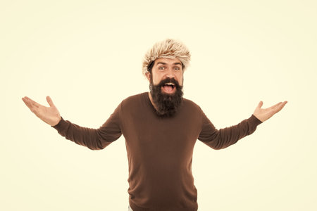 surprised brutal hipster with beard in earflape hat isolated on white background, fashionの写真素材