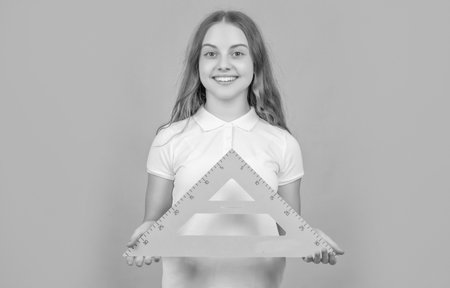 cheerful child with math triangle measuring toolの写真素材