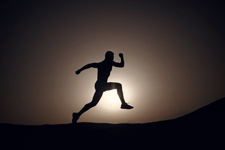 silhouette or man runner, guy running outdoor at clear skyの写真素材