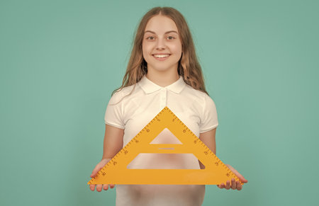 cheerful child with math triangle measuring toolの写真素材