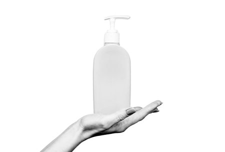 female hand hold soap bottle with copy space