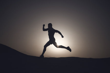 running man silhouette at sunset skyの写真素材
