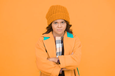 Fall go away. Unhappy little schoolchild dislike fall weather. Small girl back to school in fall. November 20 childrens day. Autumn holidays. Fall seasonの写真素材