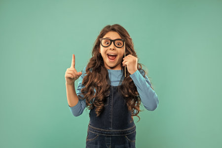 amazed inspired with idea child with curly hair hold party accessory of glasses, inspiration