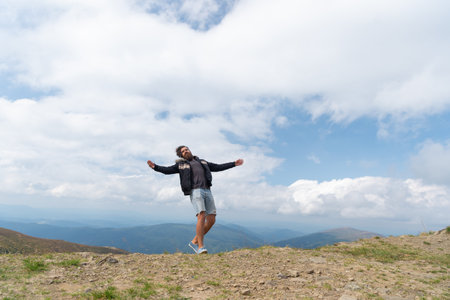 free man express freedom on mountain top. full length of free man express freedomの写真素材