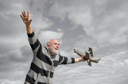 happy retirement. mature granddad with toy. retired old man outdoor. senior man at retirementの写真素材