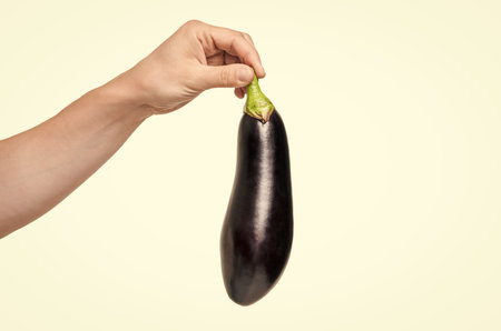 eggplant vegetable in hand isolated on white background. natural foodの写真素材
