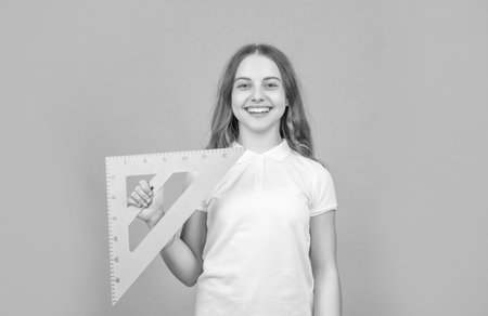 positive child with math triangle measuring toolの写真素材
