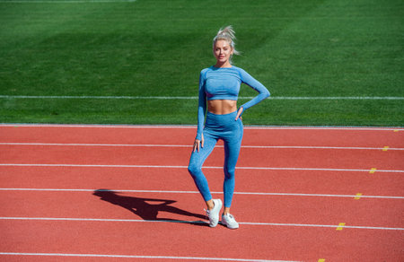 athletic woman in fitness wear on stadium, sportの写真素材