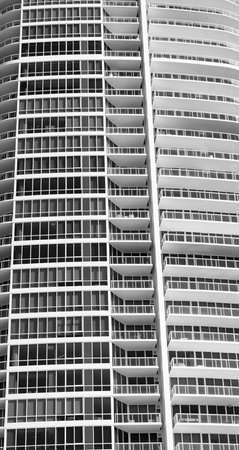 Architectural detail of high-rise apartment building facade with windows and balconies