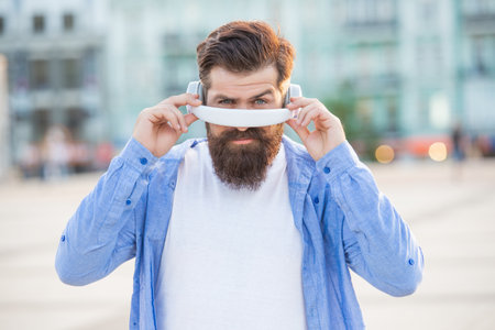 face of man hipster in music headphones in the street. photo of man hipster in music headphonesの写真素材