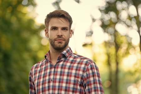 young man in checkered shirt outdoor, copy spaceの写真素材