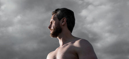 shirtless muscular man. caucasian man outdoor. man on sky backgroundの写真素材