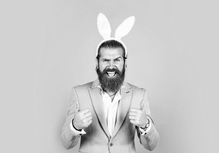 man imagine he is rabbit. male wear bunny ears. just having fun. Easter Holiday Greeting. celebrating easter in springtime. funny man in rabbit costume. happy easterの写真素材
