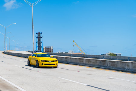 Miami, Florida USA - April 15, 2021: Chevrolet Camaro luxury yellow sport ar on road, copy space