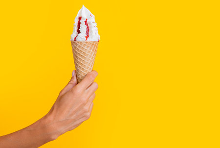 summer yummy icecream cone isolated on yellow, advertisement banner with copy space.の写真素材