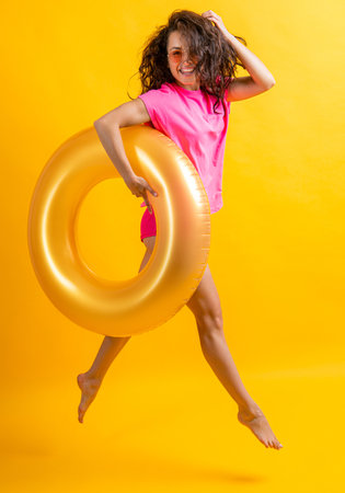 jumping woman at summer vacation in studio. woman at summer vacation on backgroundの写真素材