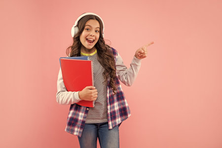 listen to music. point finger on copy space. new technology. childhood development.の写真素材