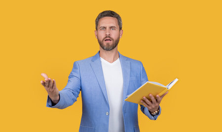 reading teacher with book in jacket. studio shot of busy teacher reading book. photo of teacherの写真素材