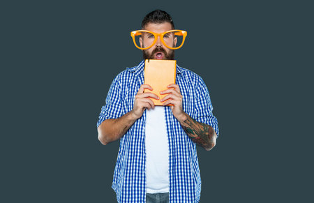 angry funny bearded man in party glasses hold book